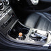 Fireball luxury car fragrance diffuser sitting in the centre cup holder of a Mercedes-Benz GLC viewed from the passenger side.