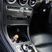 Overhead view of a Fireball luxury fragrance diffuser fitted in the centre cup holder of a Mercedes-Benz GLC.