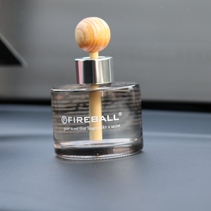 Fireball luxury car fragrance diffuser mounted on the dashboard using the included adhesive pad.