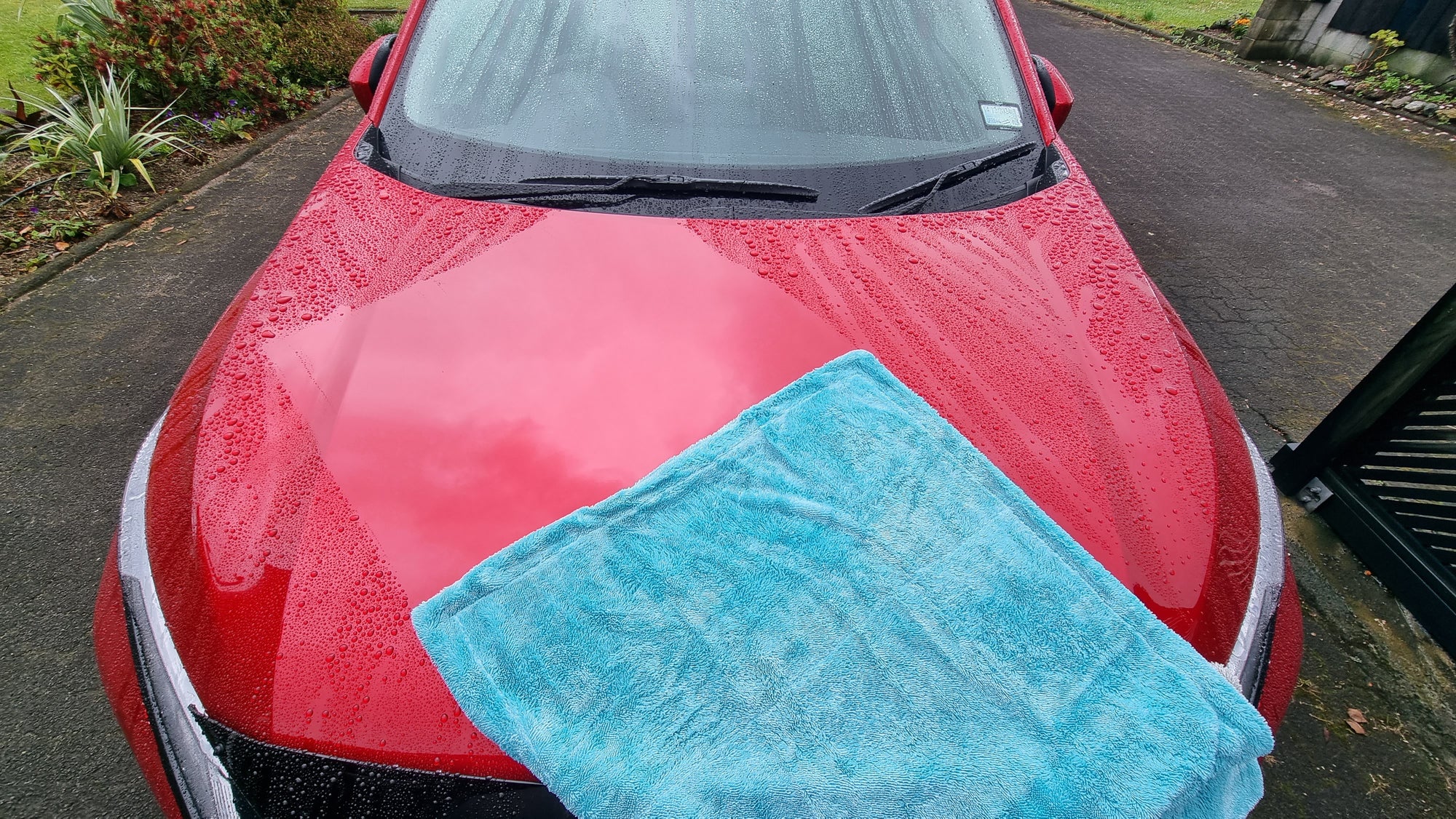 The Rockcar performer drying towel dragged across the Red car to show both how well it dries and how it does not scratch, you can see the mirror shine reflection, this was taken by Chris in Rotorua on her Mitsubishi on a phone.  A great photo we love to use at lovecars.  Thanks Chris!