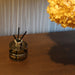 Fireball luxury fragrance diffuser with reed sticks displayed on a wooden entrance table in a modern home.