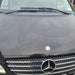 Smiley face pattern showing water spots removed from black van paint using Autostolz Water Spot Remover