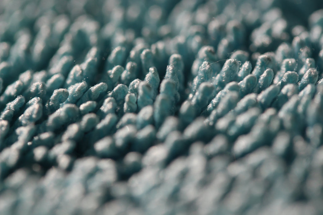 Close up of Rockcar Performer twisted loop microfiber weave teal and grey